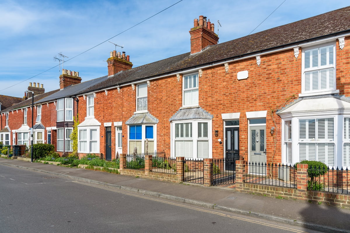 Old brick terraced houses with bay windows in an English town